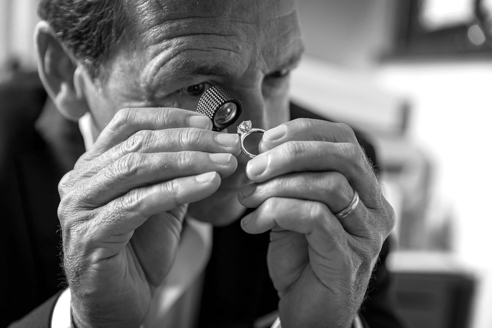 Joseph Tattersfield looking at Natural Diamond Ring through a loupe