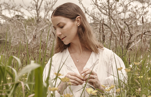 Model wearing Reclaimed diamond ring, pendant and earrings