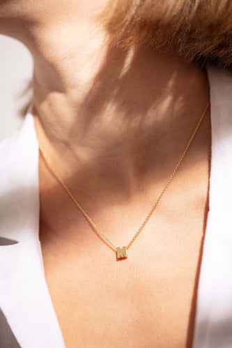 Model wearing Noted 'M' Pendant