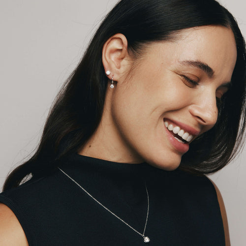 Model wearing diamond Blossom earrings and pendant